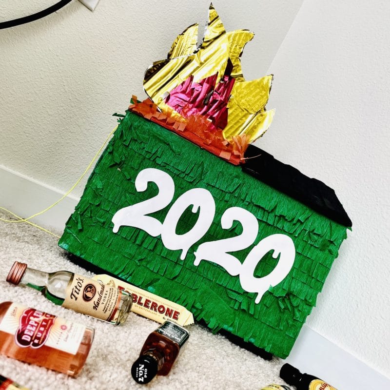 2020 Dumpster Fire pinata with liquor bottles and chocolate bars.